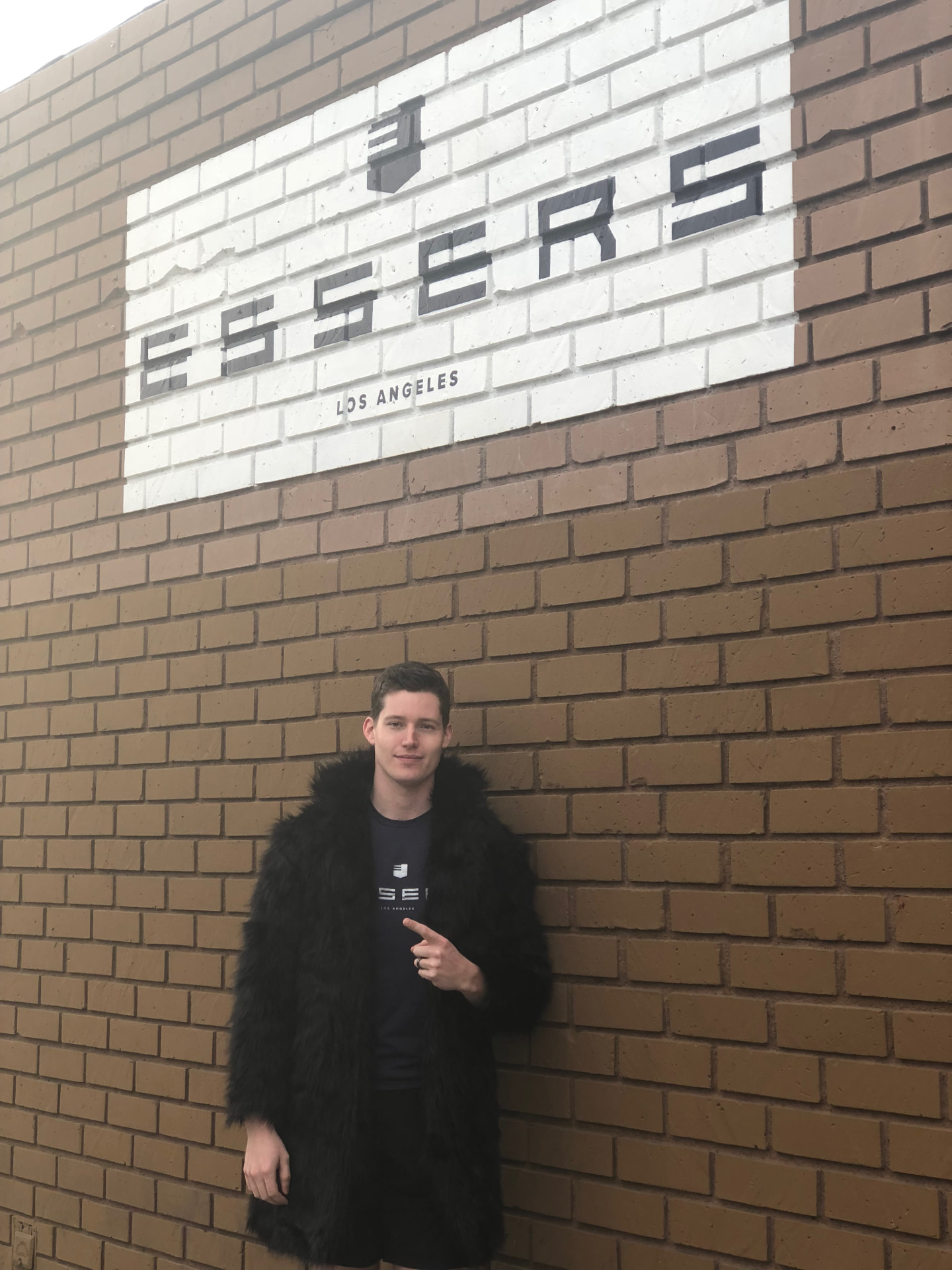 Kasey Esser standing in front of the Essers Los Angeles sign